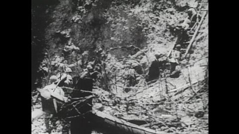 1940s Philippines: Soldiers climb ladders up hill. White flags of surrender. Prisoners stand in front of ruins.