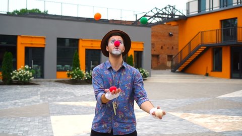 Clown Juggling Colorful Balls Outdoors.