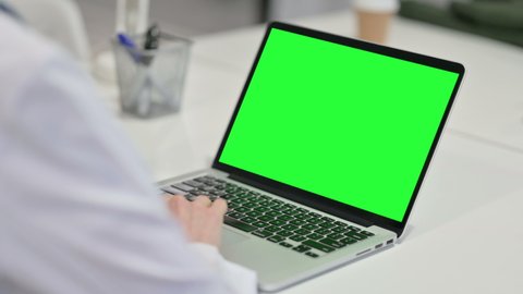 Rear View of Young Woman using Laptop with Chroma Screen 