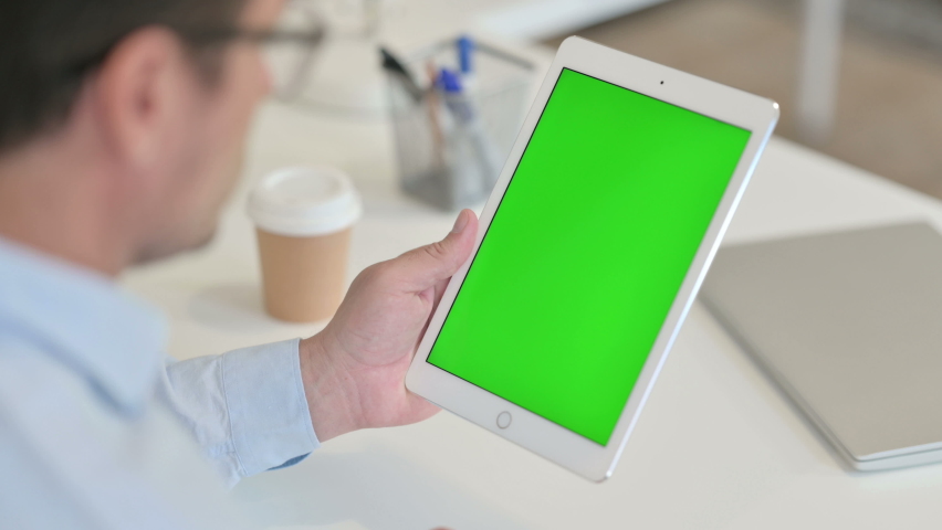 Middle Aged Man Using Tablet with Chroma Key Green Screen 