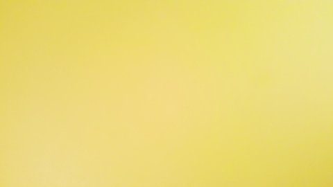 Stop motion animation. Animation of notebook opening on a blank page. Notepad on a yellow background.
