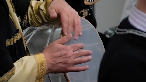 Slow motion: man hands playing ethnic azerbaijani percussion drum nagara on stage of summer open air concert - close up view. Entertainment, music, culture, leisure time and art concept