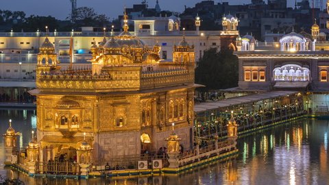 Time lapse view of thousands of Sikh pilgrims visiting the Golden Temple aka Harmandir Sahib at dusk in Amritsar, Punjab, India. 