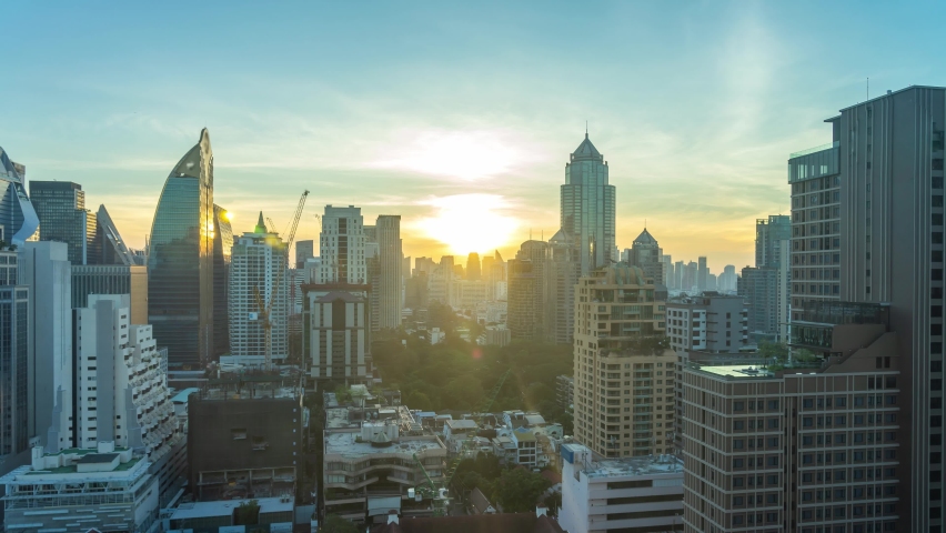 4K time lapse of sunrise scene of Bangkok skyline panorama and skyscraper in Bangkok city downtown at rooftop of Hotel, Bangkok, Thailand. Royalty-Free Stock Footage #1063009087