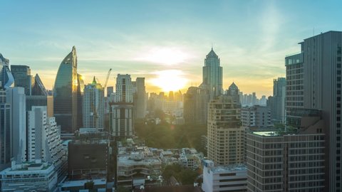 4K time lapse of sunrise scene of Bangkok skyline panorama and skyscraper in Bangkok city downtown at rooftop of Hotel, Bangkok, Thailand.