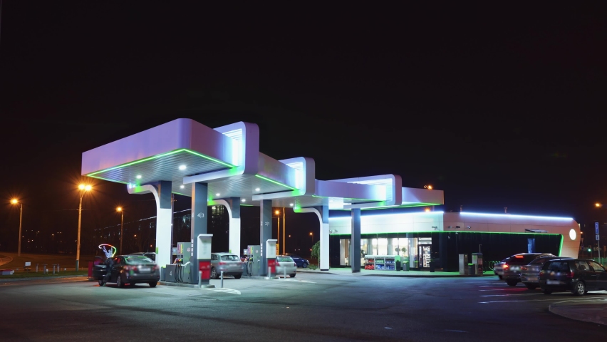 Timelapse of a gas station at night. Cars drive up to fuel stations and fill up with fuel. | Shutterstock HD Video #1063017139