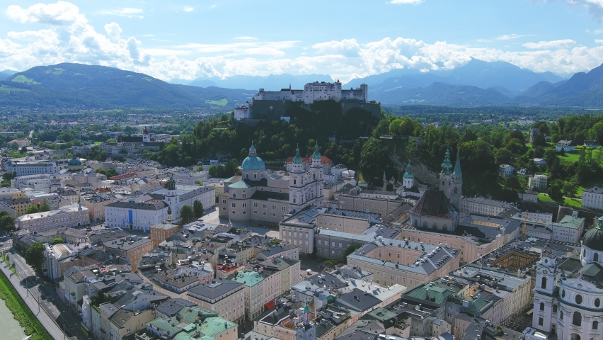 Salzburg, Austria: Aerial view of famous city landmark Fortress Hohensalzburg (Festung Hohensalzburg), medieval hilltop castle - landscape panorama of Europe from above Royalty-Free Stock Footage #1063018147