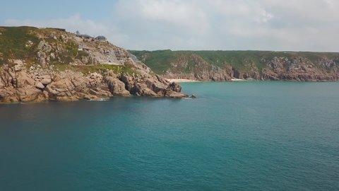 Aerial: amazing Cornwall coast and Minack Theatre on Porthcurno clifftop