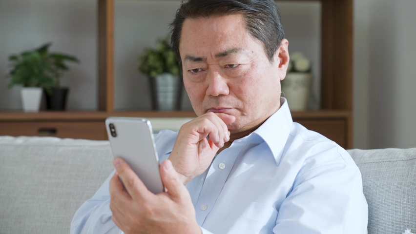 Middle-aged man using a mobile phone Royalty-Free Stock Footage #1063023667