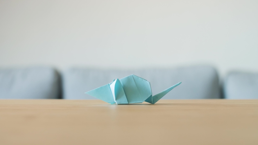 An Origami Rat leaves and Ox arrives on table. New zodiac for Chinese new year. The cow is the Chinese zodiac sign for 2021 and mouse for 2020. Animals made by hand by traditional paper folding. 4K. Royalty-Free Stock Footage #1063024345