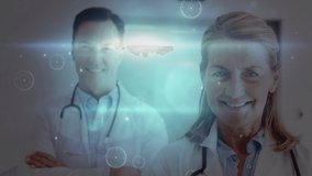 Digital animation of glowing spots of light and network of connections against portrait of male and female doctor smiling at hospital. medicine research science and global networking concept - Powered by Shutterstock - Get 15% off with code: PIKWIZARD15