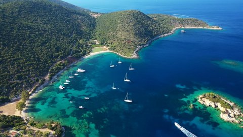 Aerial drone video of secluded paradise sandy beach of Marmagas a safe anchorage for sail boats and yachts with turquoise bay, Ithaki or Ithaca island, Ionian, Greece