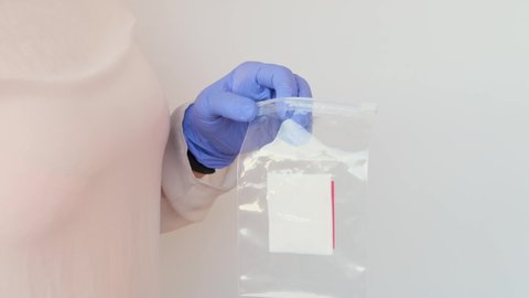 girl holds a kit for a dna test in a box, a cotton swab for scraping the epithelium, collecting genetic sample for analysis, concept of determining ethnic origin, paternity, genealogy, family tree