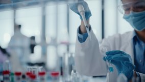 Medical Research Laboratory: Portrait of a Female Scientist Wearing Face Mask Using Micro Pipette for Analysis. Advanced Scientific Lab for Medicine, Biotechnology Development. Close-up Shot - Powered by Shutterstock - Get 15% off with code: PIKWIZARD15