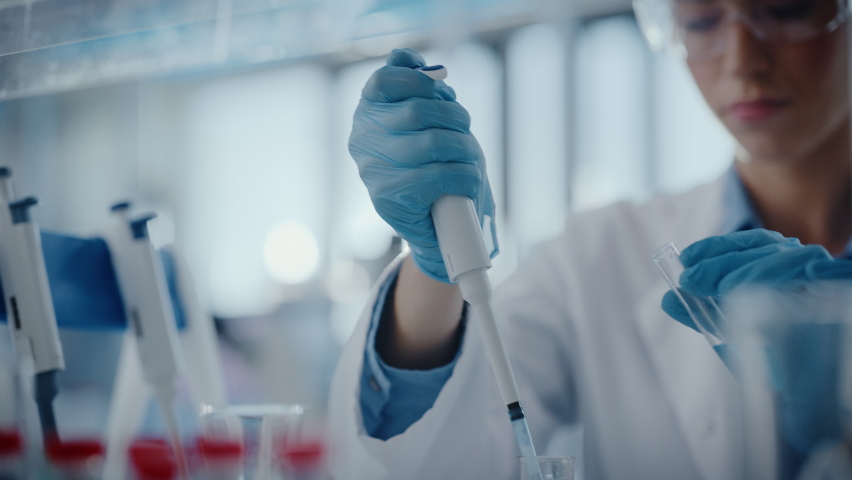 Medical Research Laboratory: Portrait of a Beautiful Female Scientist Using Micro Pipette for Analysis. Advanced Scientific Lab for Medicine, Biotechnology, Microbiology Development. Hands Close-up | Shutterstock HD Video #1063037659