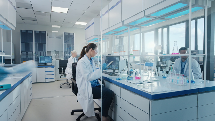 Time-Lapse in Modern Medical Research Laboratory: Team of Scientists Working Using Microscope, Analysing Microbiology Samples. Scientific Lab for Medicine, Biotechnology Development Dolly Shot | Shutterstock HD Video #1063037752