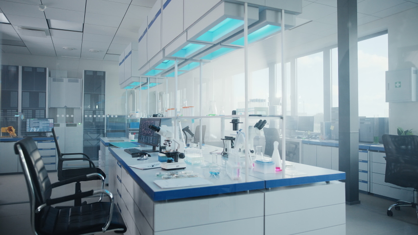 Modern Medical Research Laboratory with Computer, Microscope, Glassware with Biochemicals on the Desk. Scientific Lab Biotechnology Development Center Full of High-Tech Equipment. Moving Shot | Shutterstock HD Video #1063037842