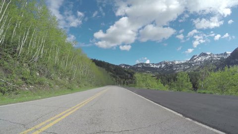 4K Gopro Car Footage Of Mountain Pass, Aspen Grove On Left, Snowcapped Mountains Ahead