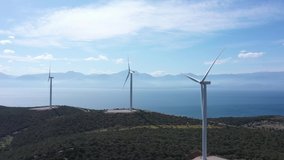 Windmills in Greece on a mountain overlooking the sea. Greece. Drone video
