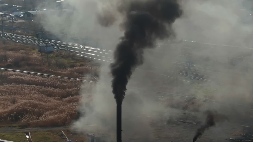 air pollution - smokestack exhausting combustion gases into the air, aerial. pipes pollute atmosphere, power plants. Industrial factory pollution by smokestacks. Industry zone, climate change, ecology Royalty-Free Stock Footage #1063047211