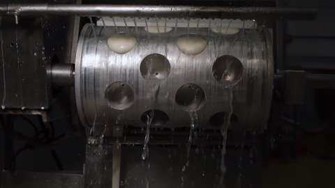Factory production dairy products, yoghurts, curd cheese. Metal steel drum holes, molds, dies for extrusion in which mozzarella located spinning doused water, pushing cheese into container sourdough