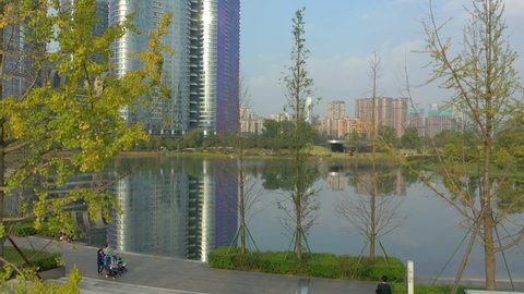 sunny day chengdu city financial district park lake aerial panorama 4k china