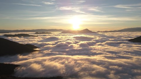 Aerial hyperlapse Peaceful sunrise wave of foggy clouds motion fast in sunny morning nature in alpine mountains heaven