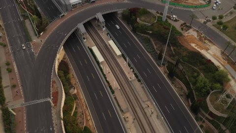 Areal shot of Wolfson Interchange in Tel Aviv during Covid 19 lockdown and quarantine with no traffic and a police barricade 