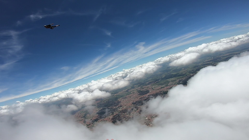 Parachutist's point of view when crossing the clouds and seeing his own shadow. | Shutterstock HD Video #1063057297