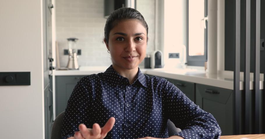 Web camera view beautiful confident millennial indian ethnic girl holding job interview online meeting making self-presentation or multiracial female blogger recording educational video indoors.