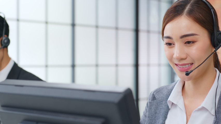 Closeup Asian woman call center, customer service, telesales in formal suit wearing headset or headphone talking with customer in modern office Royalty-Free Stock Footage #1063059109