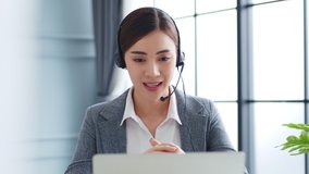 Young Asian businesswoman, call center, customer service with headset or headphone talking on video call conference or virtual meeting in office - Powered by Shutterstock - Get 15% off with code: PIKWIZARD15