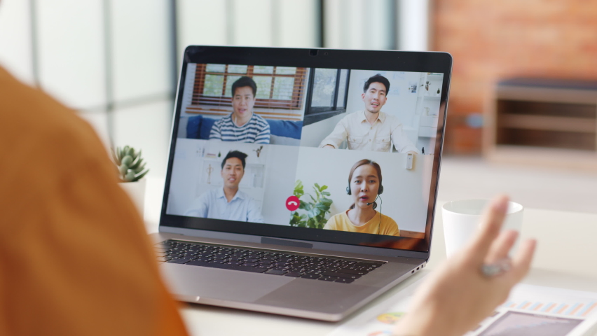 Young Asian businessman work at home and virtual video conference meeting with colleagues business people, online working, video call at home office | Shutterstock HD Video #1063059364