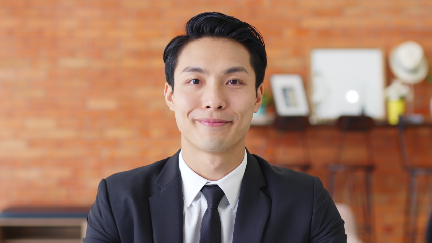 POV Young Asian businessman talking on video call or virtual meeting in office, front view, look at camera | Shutterstock HD Video #1063059382