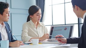 Group of Asian business people working, meeting about business plan and present and explain financial chart from laptop computer. - Powered by Shutterstock - Get 15% off with code: PIKWIZARD15