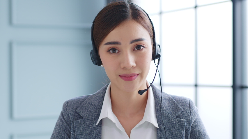 POV Young Asian businesswoman, call center, customer service talking on video call conference or virtual meeting in office, front view, look at camera Royalty-Free Stock Footage #1063059400