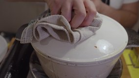 Stirring pasta vegetable sauce with wooden kitchen spoon inside cooking pot. Slow motion. Close up shot.