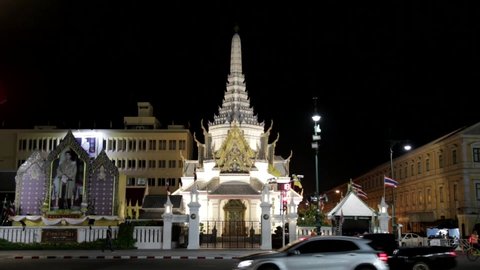 Bangkok, Thailand - November 2020: The City Pillar Shrine lit up at night as vehicles pass by.