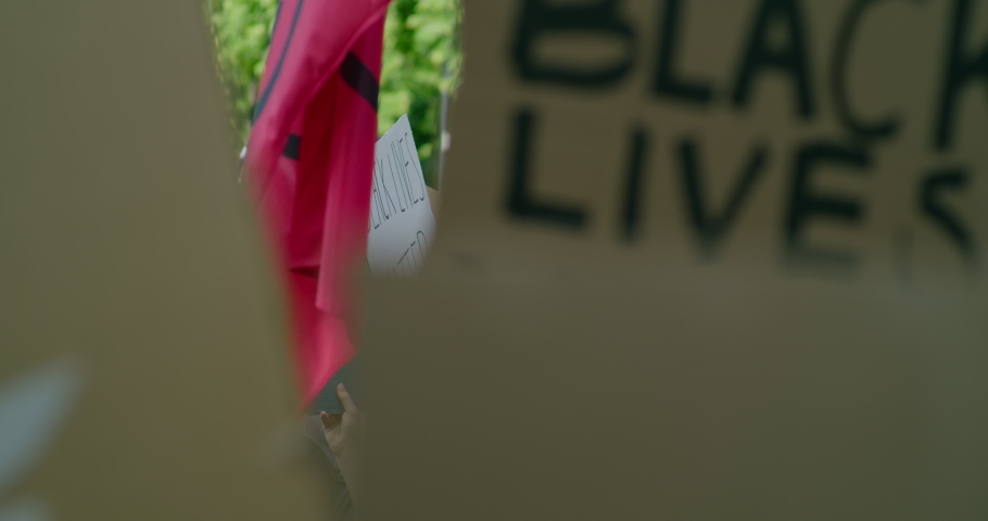 Black Lives Matter BLM Protest in Europe. Solidarity Demonstration with Signes against Police Brutality and Injustice. Crowds of People Gathering for Racial Equality Royalty-Free Stock Footage #1063075636
