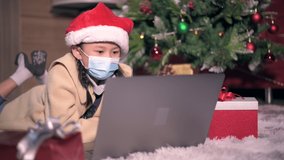The girl with the Christmas costume video calling during the Coronavirus pandemic. the concept of Christmas, festival, COVID-19 and healthcare. 