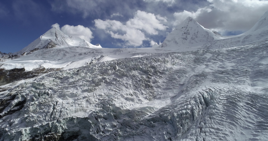 Drone flying approaching fossil glacier and snow mountains in tibet, China Royalty-Free Stock Footage #1063078828