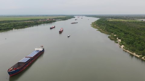 River barge for transportation of goods, top view, Aerial photo of barge, his flat-bottomed boat is mainly built for river and canal transport of heavy goods, 
flight over the river with steamships