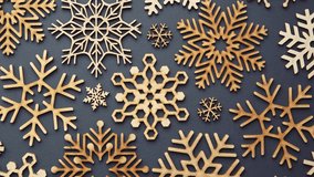 Flat lay winter holiday decor.Handmade Christmas and New Year holidays decorations made from natural wood.Wooden snowflakes filmed directly from above with zoom effect