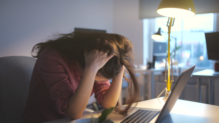 Worried business woman face looking at laptop in office. Close up of upset businesswoman thinking about mistakes in work. Portrait of sad girl looking laptop. Depressed employee working on laptop | Shutterstock HD Video #1063089691