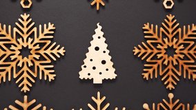 Christmas wooden decor filmed in flat lay on black background directly from above in 4K ultra hd video clip.Beautiful handmade toy for Christmas tree decoration on New Year Eve.Hand crafted wood toys
