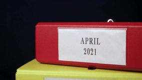 Folders with Documents for tax april 2021 and Taxes returns for accountant next to calculator. Vertical slide video shot. Close-up