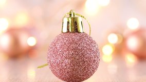 Glitter rose gold Christmas ornament with blinking lights on light theme - Powered by Shutterstock - Get 15% off with code: PIKWIZARD15