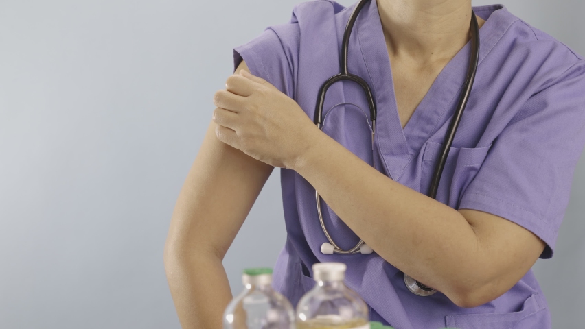 Doctor doing vaccine injection to Medical personnel in hospital.