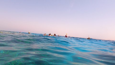 Sharm El Sheikh, Egypt - September 10, 2020: A group of tourists swims in the Red Sea near pleasure boats at Sharm El Sheikh, Egypt on September 10, 2020. Snorkeling in the open sea. People snorkel