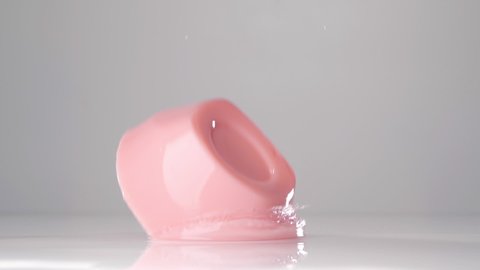 Pink jelly falling down. Сlose up slow motion